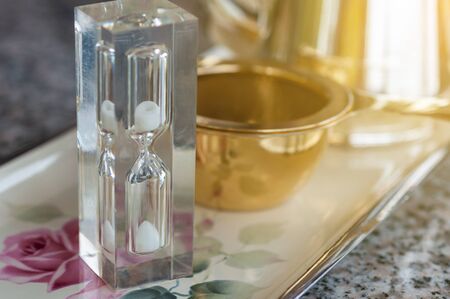 Hourglass timing with filter and tea set, tea break on afternoon.の写真素材