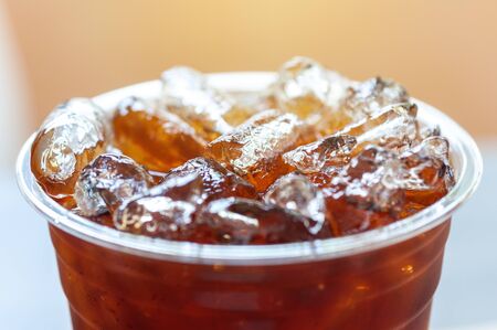 Ice americano coffee in PET plastice glass, fresh beverage with small ice refreshment in morning.