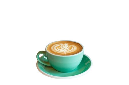 Fresh latte coffee in green cup on marble table with copy space.