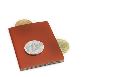 Golden Silver and bronze bitcoin with red book, financial investment conception with copy space.の写真素材