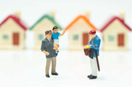 Selective focus miniature people life style in community concept, man with son talking with...