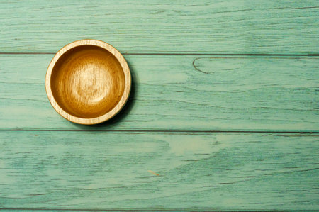 Empty wood cup on green wood, top view.の写真素材