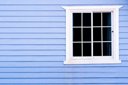 White frame vintage window on blue wooden wall.の写真素材