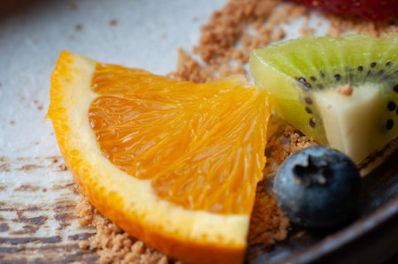 Mix slice fruit on plate, orange strawberry kiwi fruit and blackberry decorate on plate.の写真素材