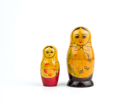 small and big wooden dolls on white backgroundの写真素材
