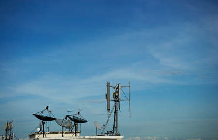 Satellite dish on roof and blue sky on backgroundの写真素材