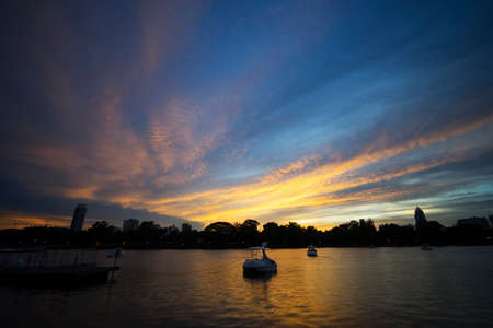 Twilight in bangkok city beautiful sky on background and lake on foregroundの写真素材
