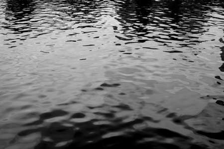 Soft focus black and white reflection on water in low light