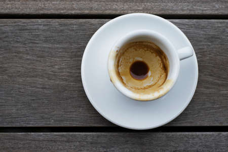 Top view of white empty espresso cup on wood table.の写真素材