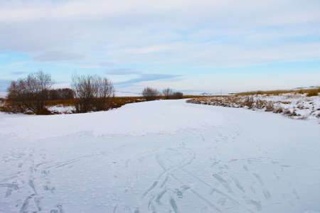 Traces of feet on the frozen river.の写真素材