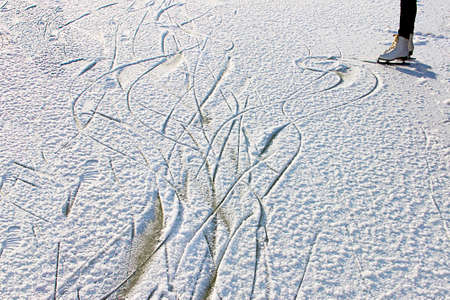 Winter fun - skating on the frozen river.の写真素材