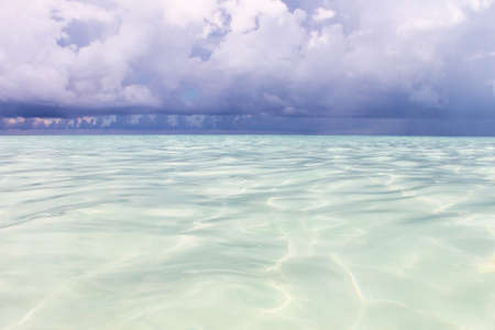 The ocean before the rain. Summer juicy seascape. The Caribbean Sea with turquoise water, in the...