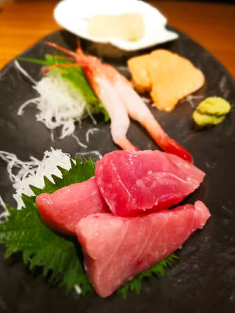 National Japanese food: tuna, shrimps, scallops with finely chopped daikon and green leaf seasoning.の写真素材