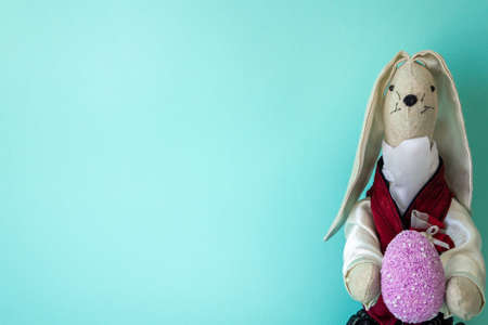 Easter card with a rabbit egg and a place for text on a blue background. minimalismの写真素材