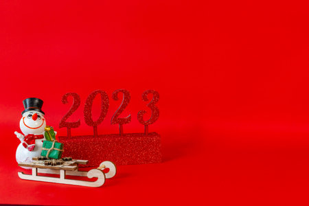 New Years composition with the numbers 2023 on a red background with a place to copy. High quality...