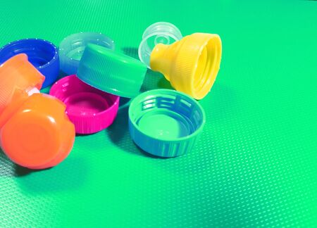 Plastic bottle screw caps isolated on green.の写真素材