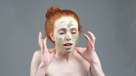 The image of an irritated attractive young model with a mask on her face. Irritated expression.の写真素材