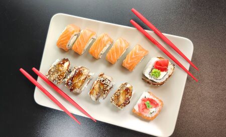 Beautiful of sushi rolls with red chopsticks on a plate. Top viewの写真素材