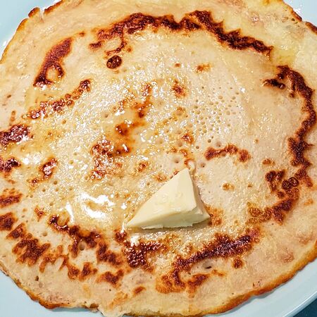 delicious pancake with butter on a plate. pancake on a plate with a piece of butter. freshly made...