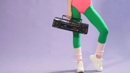 dancer preparing for an aerobics competition is holding a portable tape recorder.の写真素材