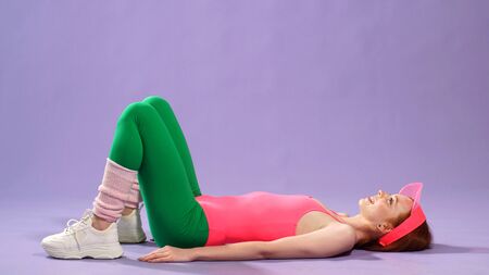 red-haired girl doing Pilates training in the gym. fitness trainer.