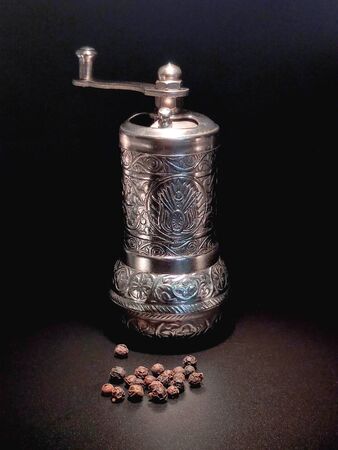 Oriental brass pepper pot with silver on an isolated background.の写真素材