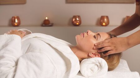 the Girl in the Spa salon gets a head massage. Relaxing massage.の写真素材