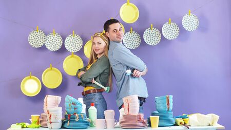 young Married couple is preparing for household chores, cleaning dishes after the holiday.の写真素材