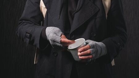 Close-up of the hands of a homeless old man, a homeless man counting coins to eat and drink.の写真素材