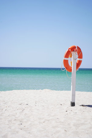 Lifebuoy on the background of the azure sea and blue sky.の写真素材