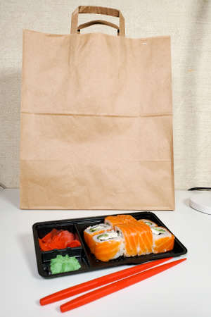 Japanese sushi roll for dinner on an isolated white background. The concept of the delivery of Japanese dishesの写真素材