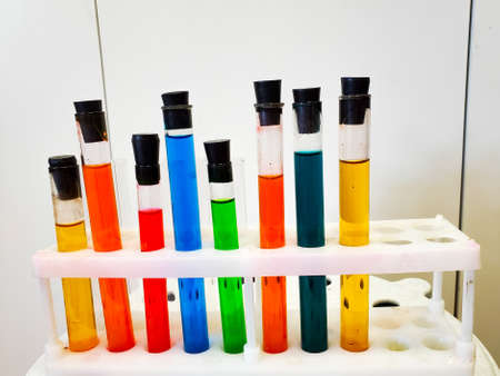 Laboratory tableware with colorful liquid. Multicolored liquid in a laboratory dish, close-up.の写真素材