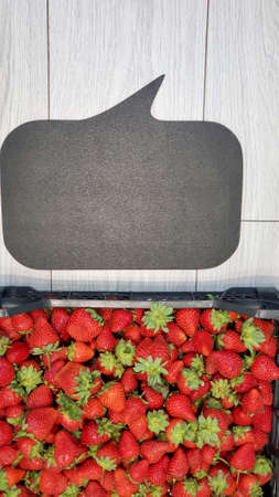 Large red ripe strawberries in a plastic box. Close-up of a large strawberryの写真素材