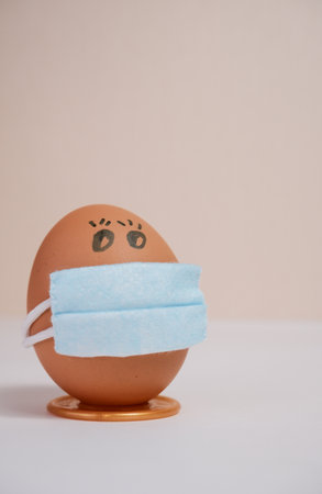 Easter eggs with virus protection concepts. Easter eggs in a medical mask to decorate the Easter...