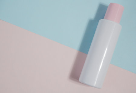 liquid makeup remover, cream, spa plastic white bottle on white and blue background.の写真素材