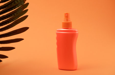 Orange pure tanning lotion or sunscreen bottle for packaging mockup. Bottle and orange background....