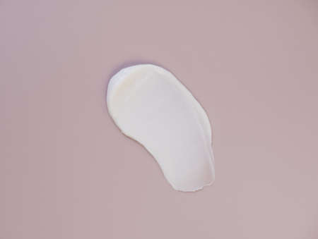 White cream texture on a pink background.の写真素材