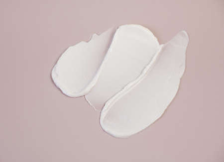 White cream texture on a pink background.の写真素材