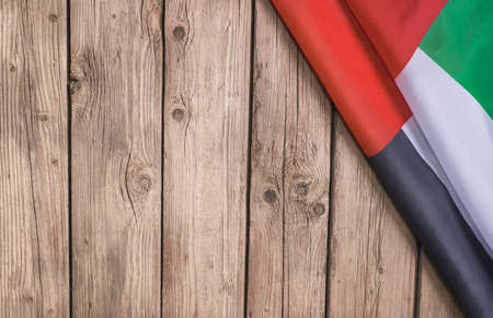 Flag of the United Arab Emirates and place for text on a dark wooden background.の写真素材