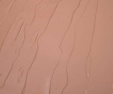 Makeup base cream blur, red clay mask texture. background.の写真素材