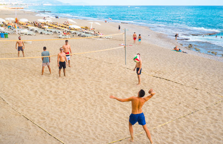 Alanya, Turkey - August 29, 2022: Beach volleyball court with men playing on the beach in Alanya. Turkey.のeditorial素材