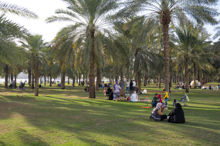 SHARJAH, UNITED ARAB EMIRATES - FEBRUARY 10, 2023:Locals relaxing on the waterfront of Khalid Lakeのeditorial素材