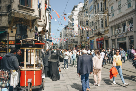 Istanbul, Turkey - May 02, 2023: Nostalgic traditional red tram in Beyoglu. The tram line runs along...