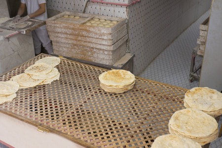 Local bakery of traditional Turkish bread. Fresh flatbread that is baked on a baking sheet or baking...