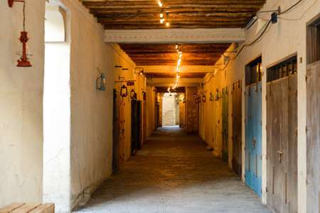Narrow streets that create shade on a hot day in the old city of Dubai Creek and Bur district. Travel destinations and heritage village.の写真素材