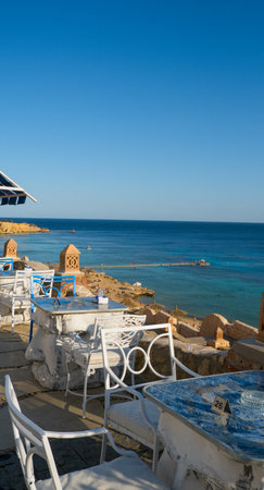 Beautiful white and blue street cafe on the seashoreの写真素材
