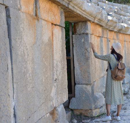 A woman tourist touches the ruins of the ancient Lycian city of Myra. Demre, Antalya, Turkey.の写真素材