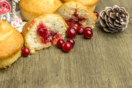 Freshly baked cranberry buns a lot of cranberries on a wooden backgroundの写真素材