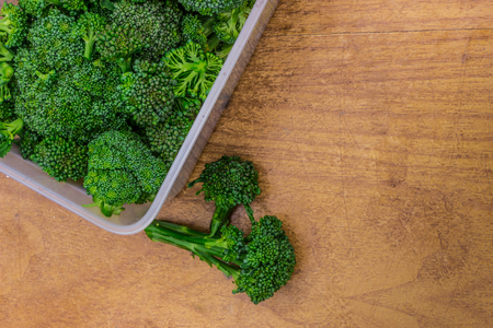 Broccoli collected from the garden in the country, in a tray on a wooden table. Fresh broccoli.の写真素材