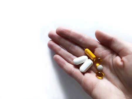 Different vitamins in the palm of your hand.の写真素材